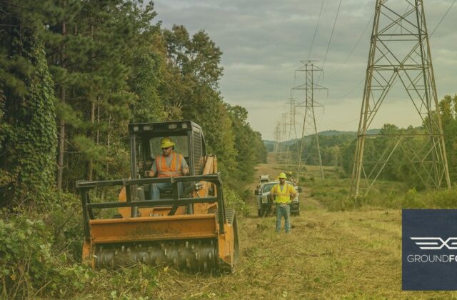 A utility vegetation management crew clearing a transmission line right-of-way corridor through dense Georgia forestland.